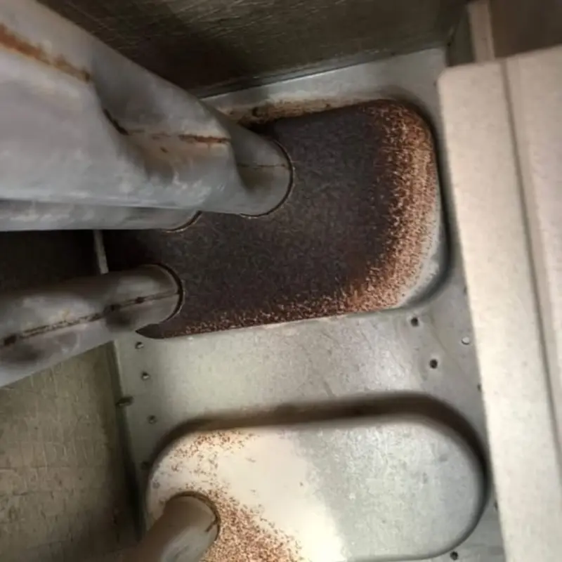 Cracked heat exchanger with burn marks showing carbon monoxide leak risk in Las Vegas home