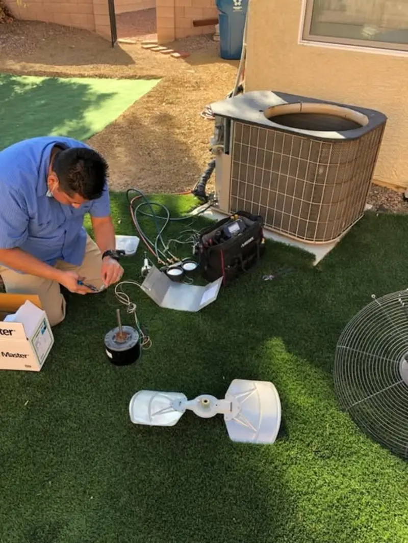 We Care Air technician repairing residential AC unit in Las Vegas backyard